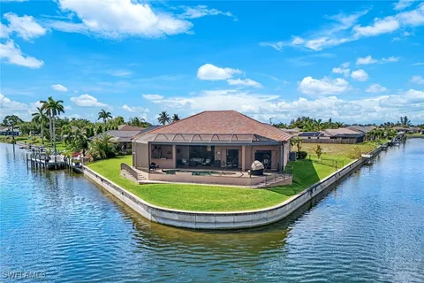 a view of a house with swimming pool and sitting area