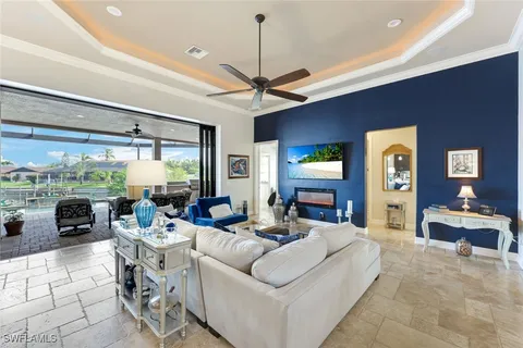 a living room with fireplace furniture and a large window
