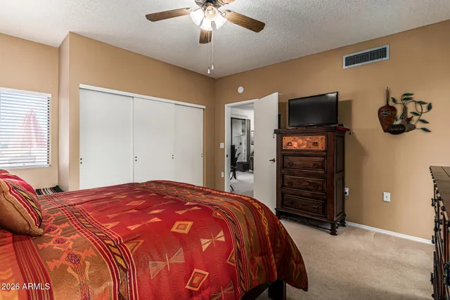 a bedroom with a bed and a television