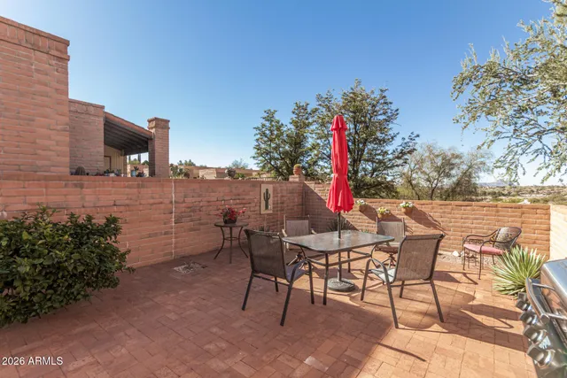 a view of a chairs and table in patio