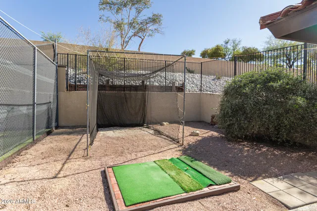 a backyard of a house with table and chairs