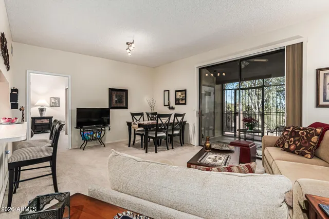 a living room with furniture and large windows