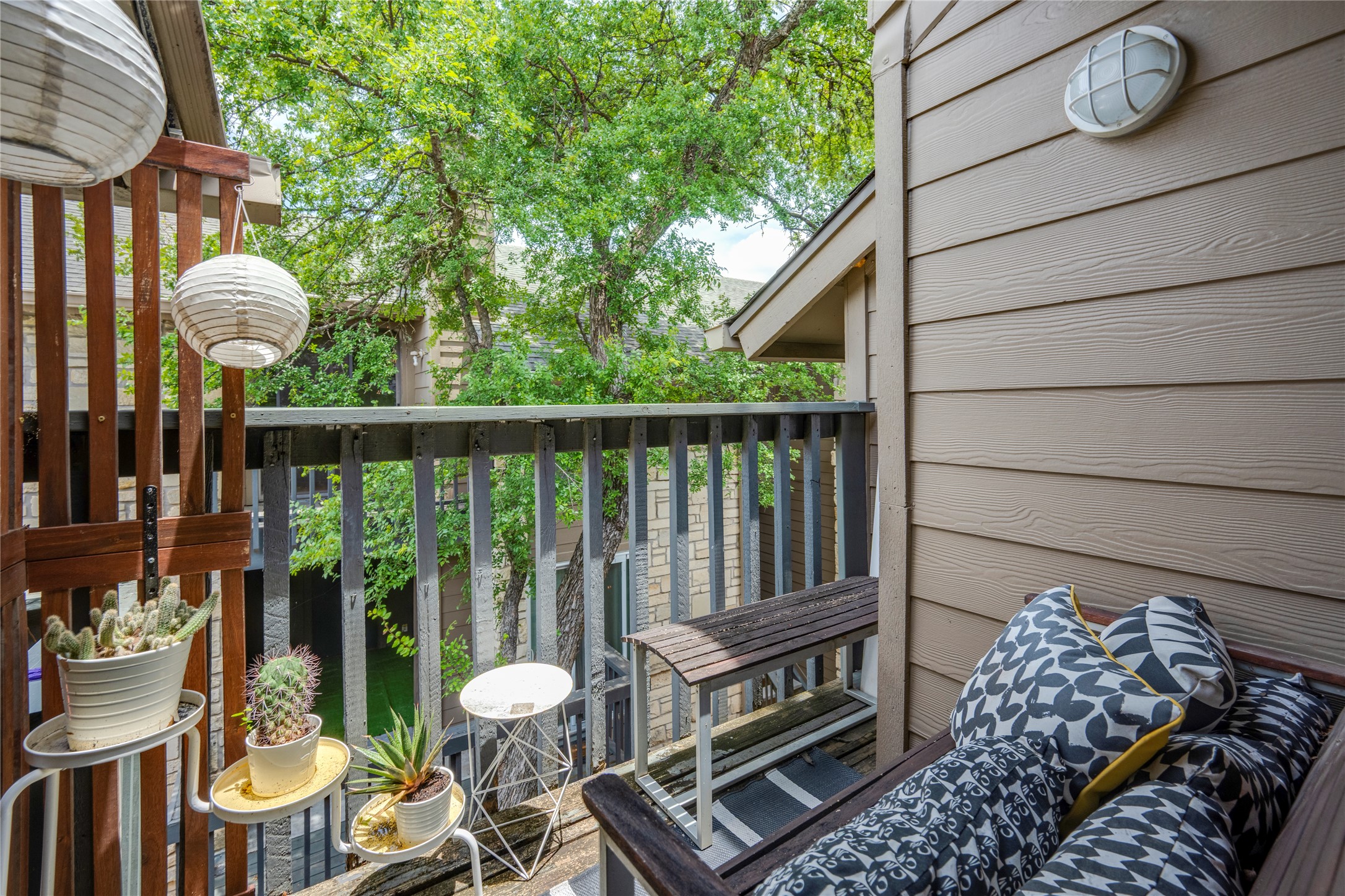 3627 Menchaca Road, Unit 214 Austin, TX 78704 - Photo 20 of 28 An inviting balcony escape awaits, framed by lush greenery and offering a private outdoor retreat.