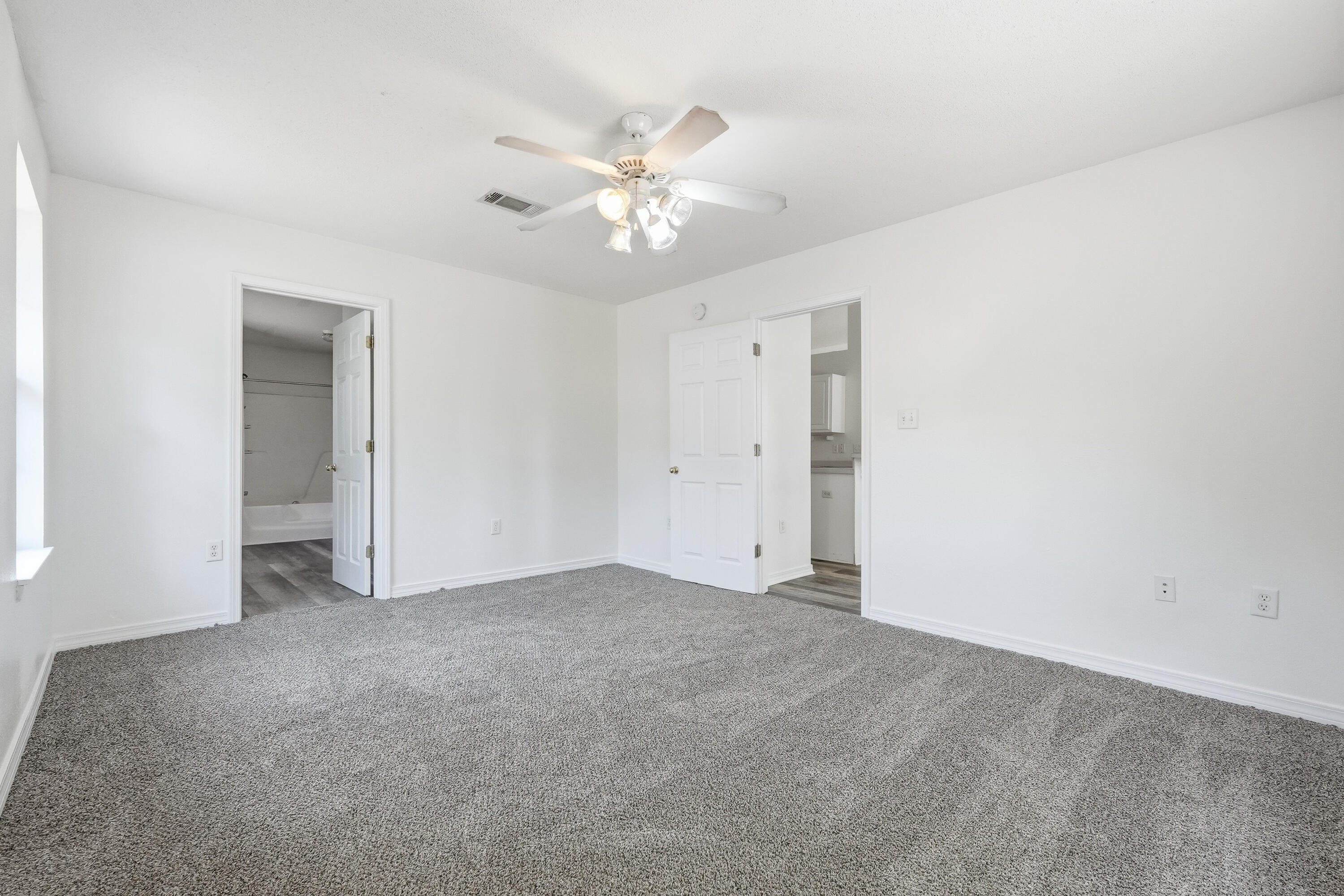 4087 Audiss Road Milton, FL 32583 - Photo 23 of 34 a view of an empty room with a ceiling fan