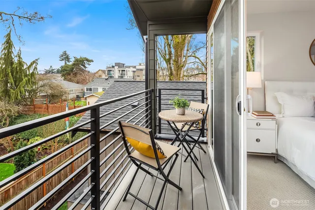a view of a balcony with furniture and a potted plant