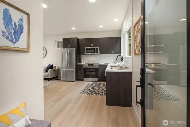 a kitchen with stainless steel appliances granite countertop a refrigerator and a sink