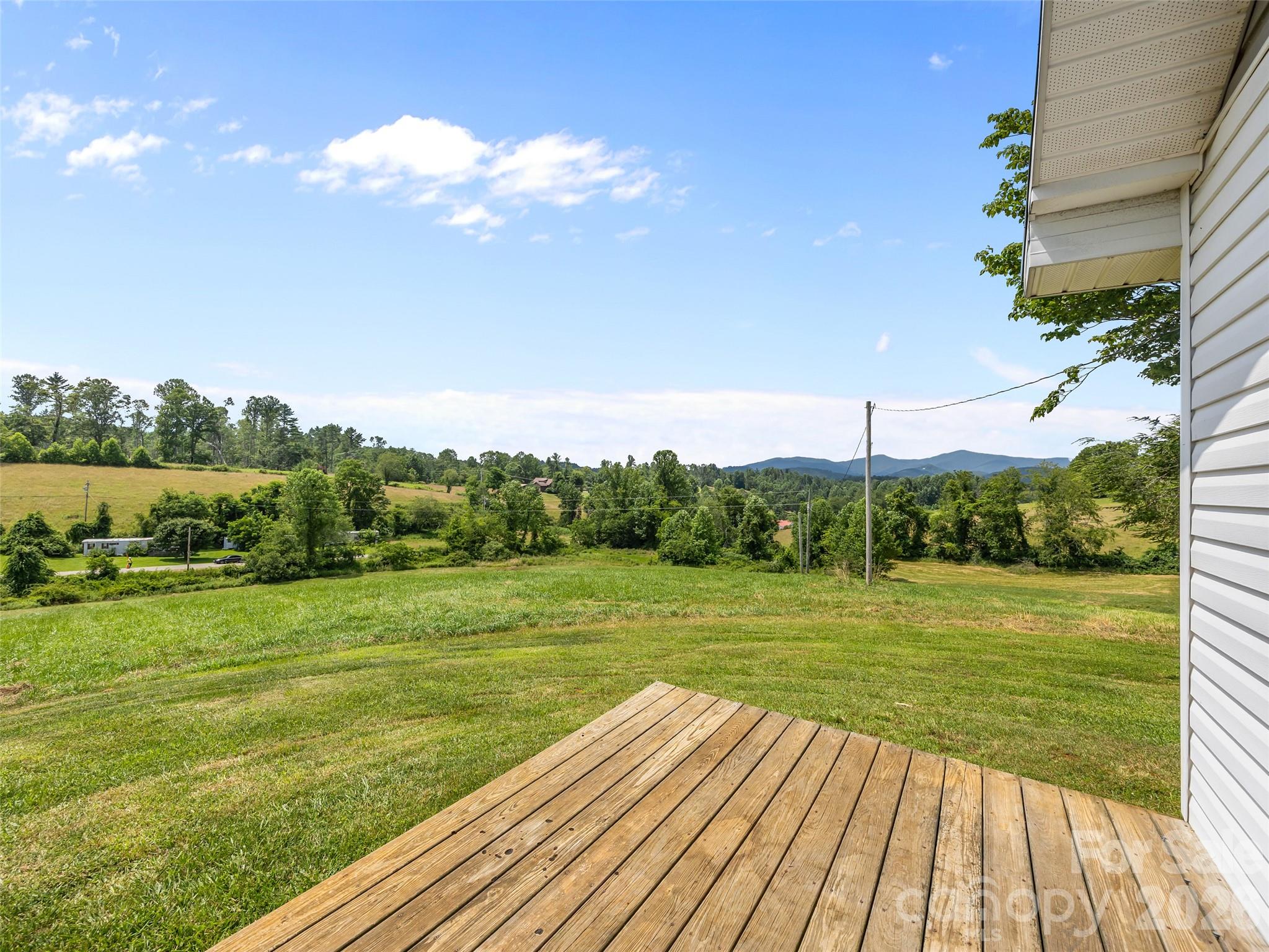 1305 Halltown Road Spruce Pine, NC 28777 - Photo 23 of 45 a view of a big yard with an ocean view