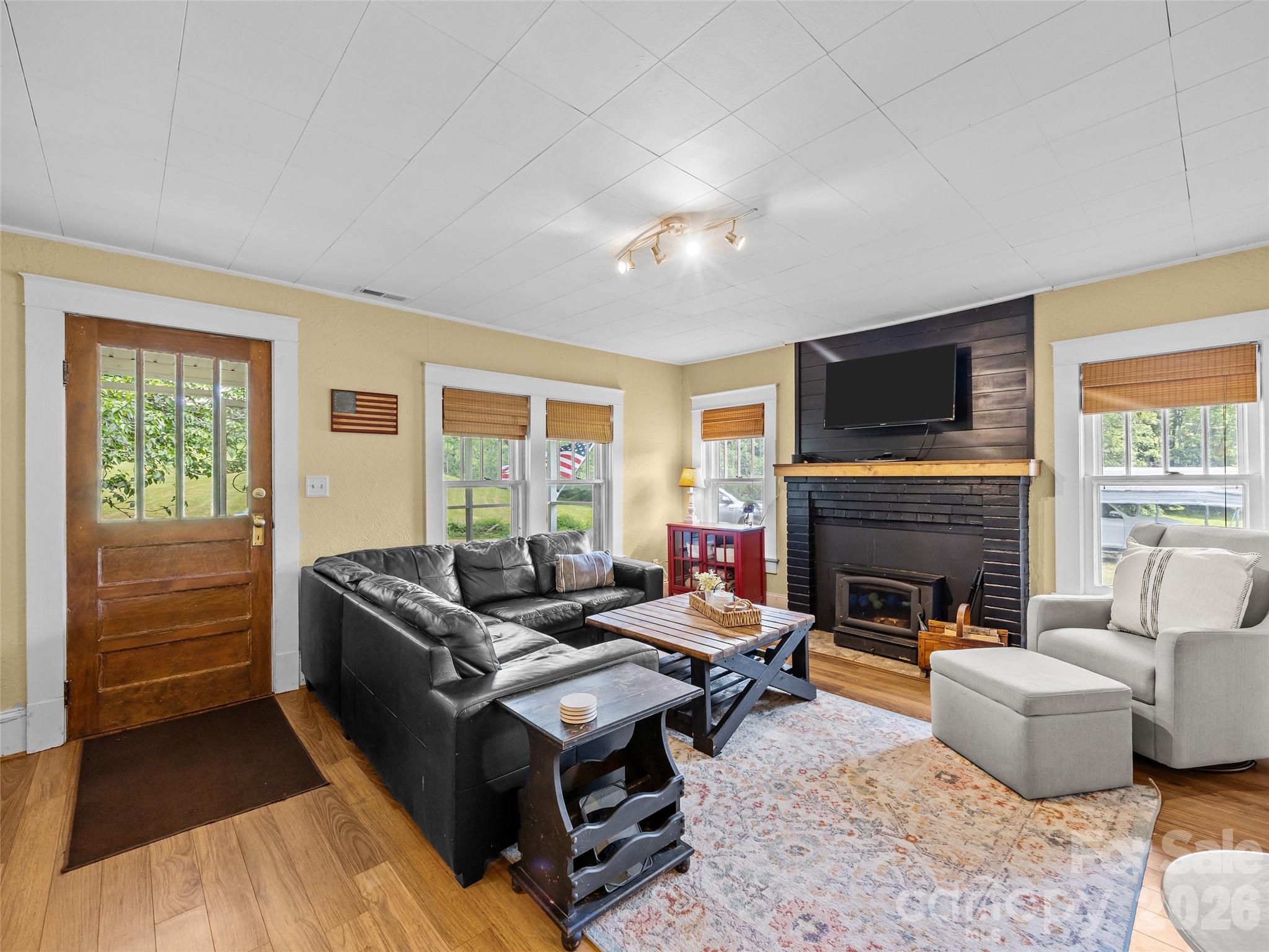 1305 Halltown Road Spruce Pine, NC 28777 - Photo 24 of 45 a living room with furniture flat screen tv and a fireplace
