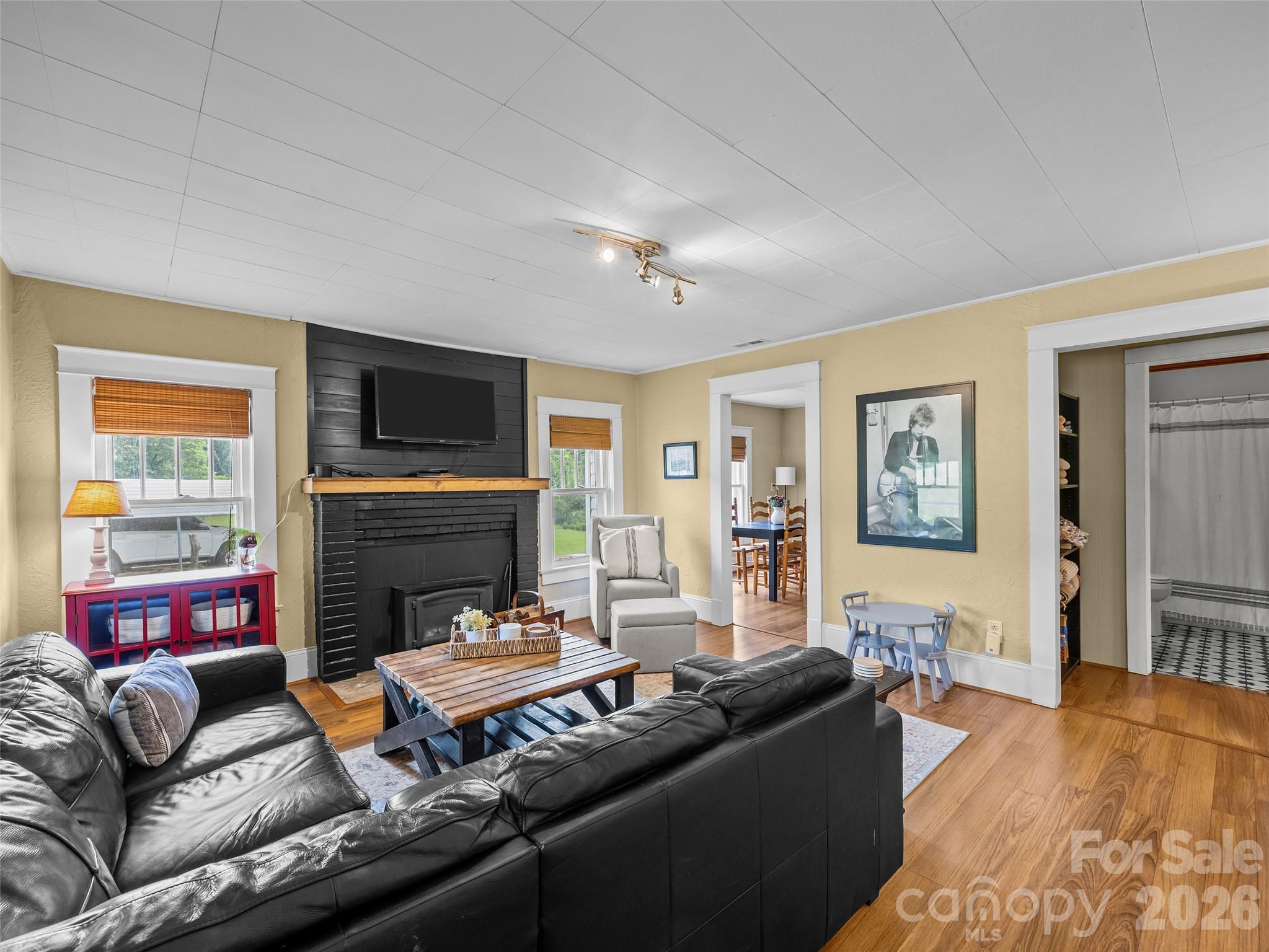 1305 Halltown Road Spruce Pine, NC 28777 - Photo 26 of 45 a living room with furniture fireplace and a flat screen tv