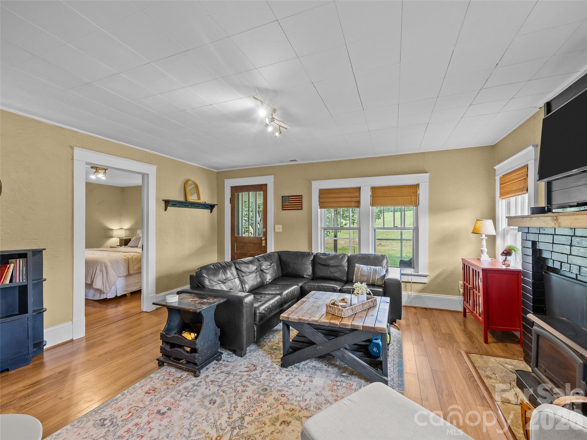 1305 Halltown Road Spruce Pine, NC 28777 - Photo 28 of 45 a living room with furniture fireplace and a window