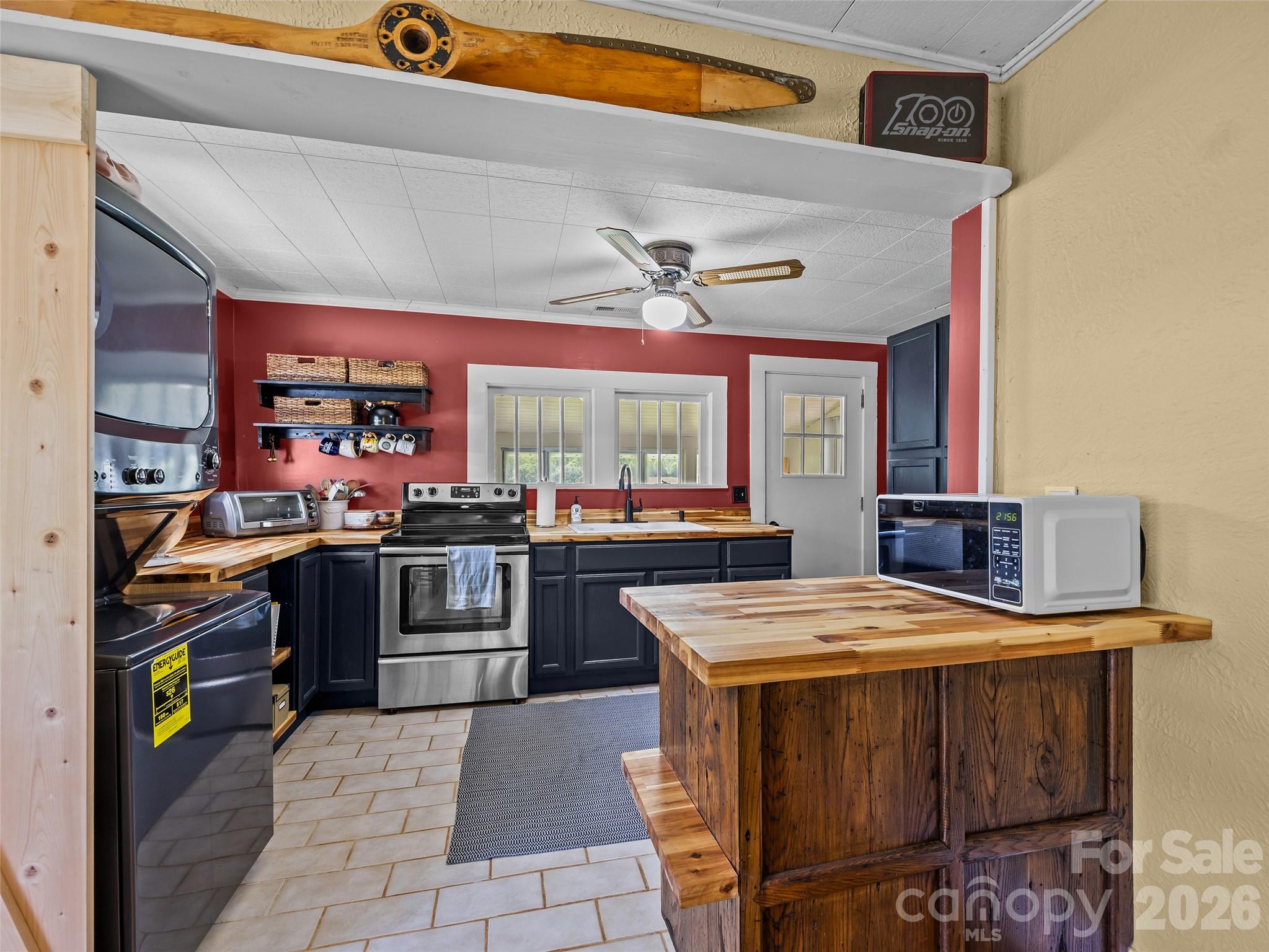 1305 Halltown Road Spruce Pine, NC 28777 - Photo 33 of 45 a kitchen with stainless steel appliances granite countertop a stove and a sink