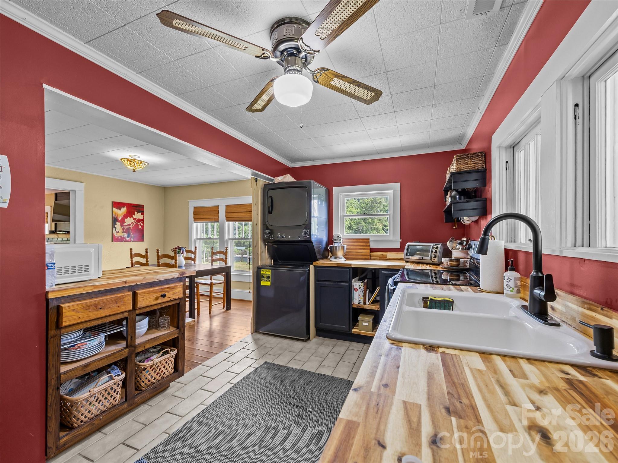 1305 Halltown Road Spruce Pine, NC 28777 - Photo 36 of 45 a large kitchen with stainless steel appliances granite countertop a stove oven a sink dishwasher a dining table and chairs with wooden floor