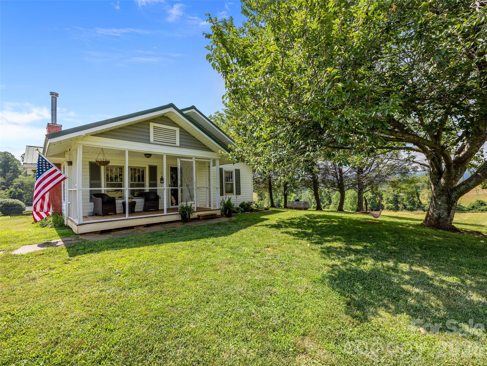 1305 Halltown Road Spruce Pine, NC 28777 - Photo 39 of 45 a view of a house with a yard