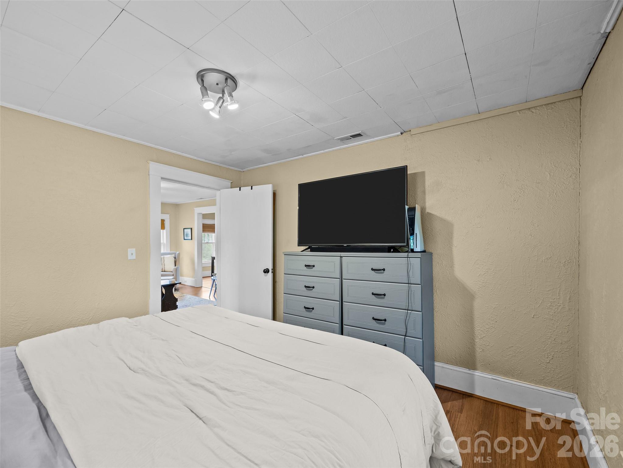 1305 Halltown Road Spruce Pine, NC 28777 - Photo 40 of 45 a bedroom with a bed and a flat screen tv