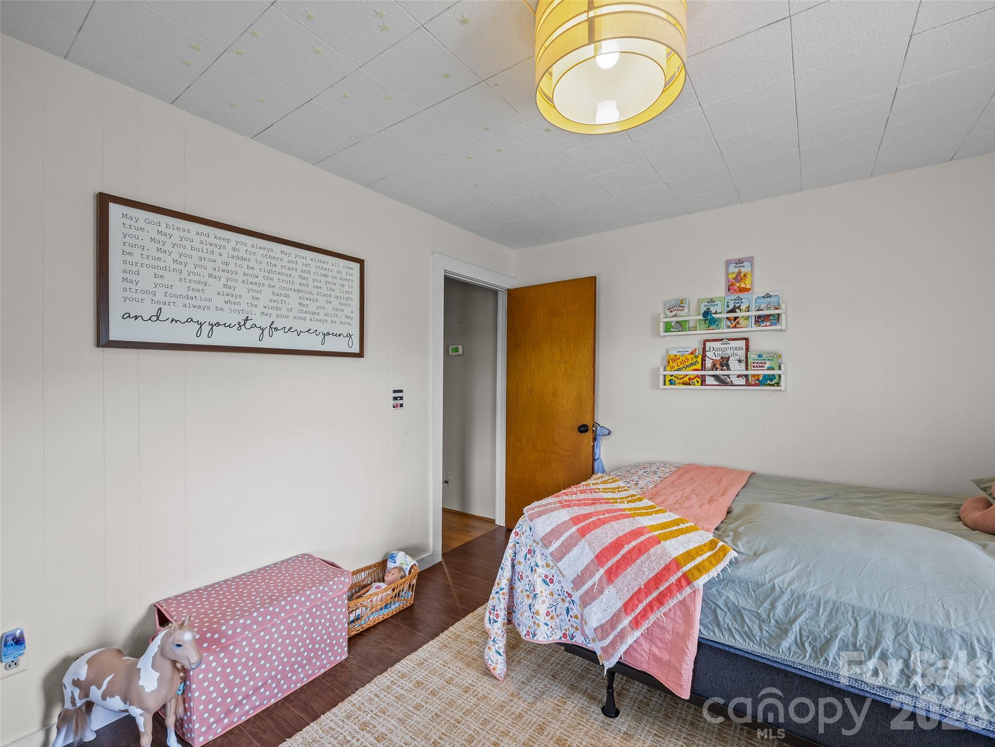 1305 Halltown Road Spruce Pine, NC 28777 - Photo 45 of 45 a bedroom with a bed and a lamp