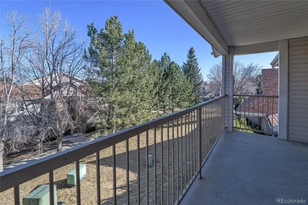 a view of a balcony with trees