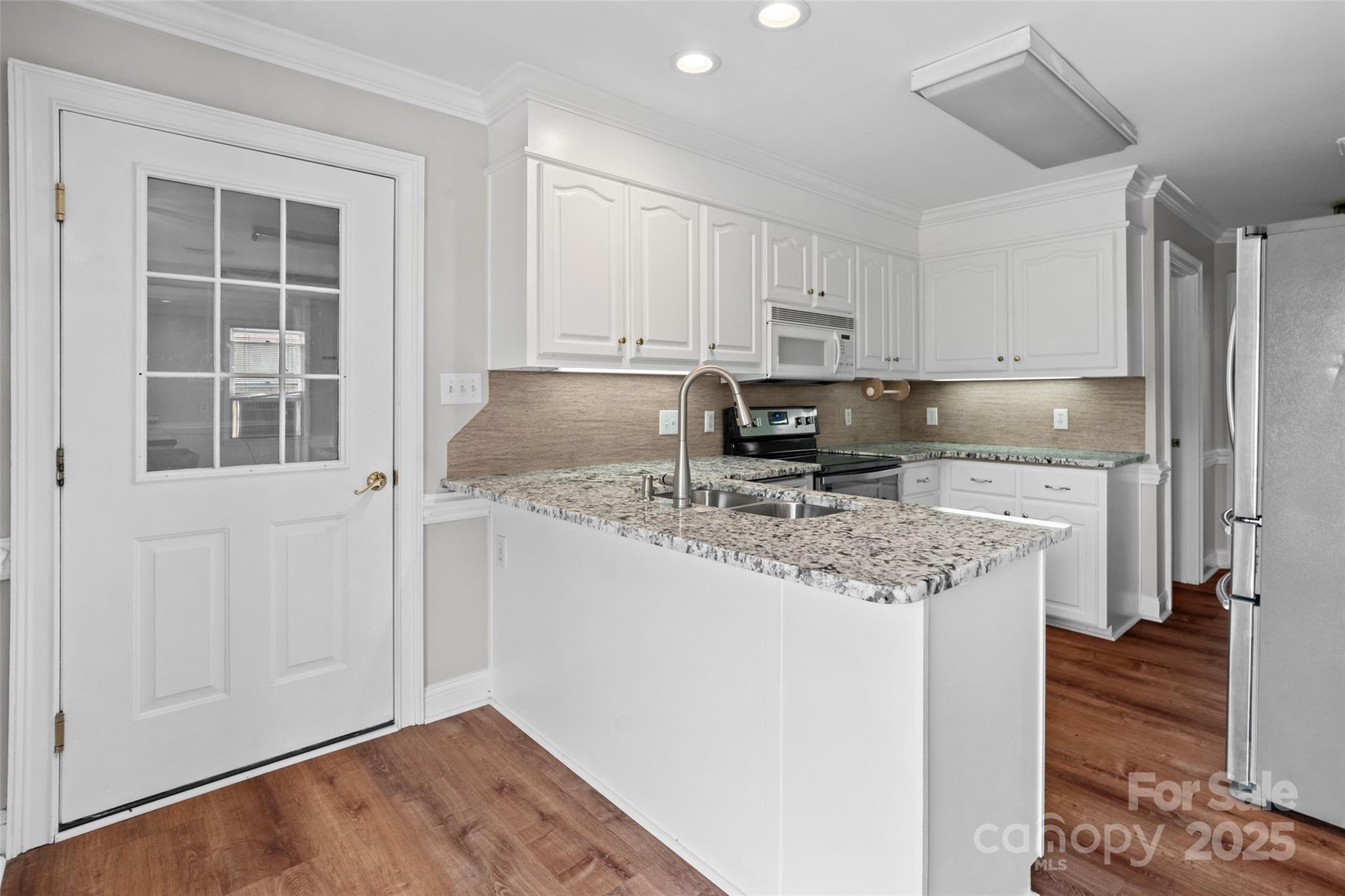 2082 Egret Court Rock Hill, SC 29732 - Photo 11 of 36 a kitchen with stainless steel appliances granite countertop a sink stove and cabinets
