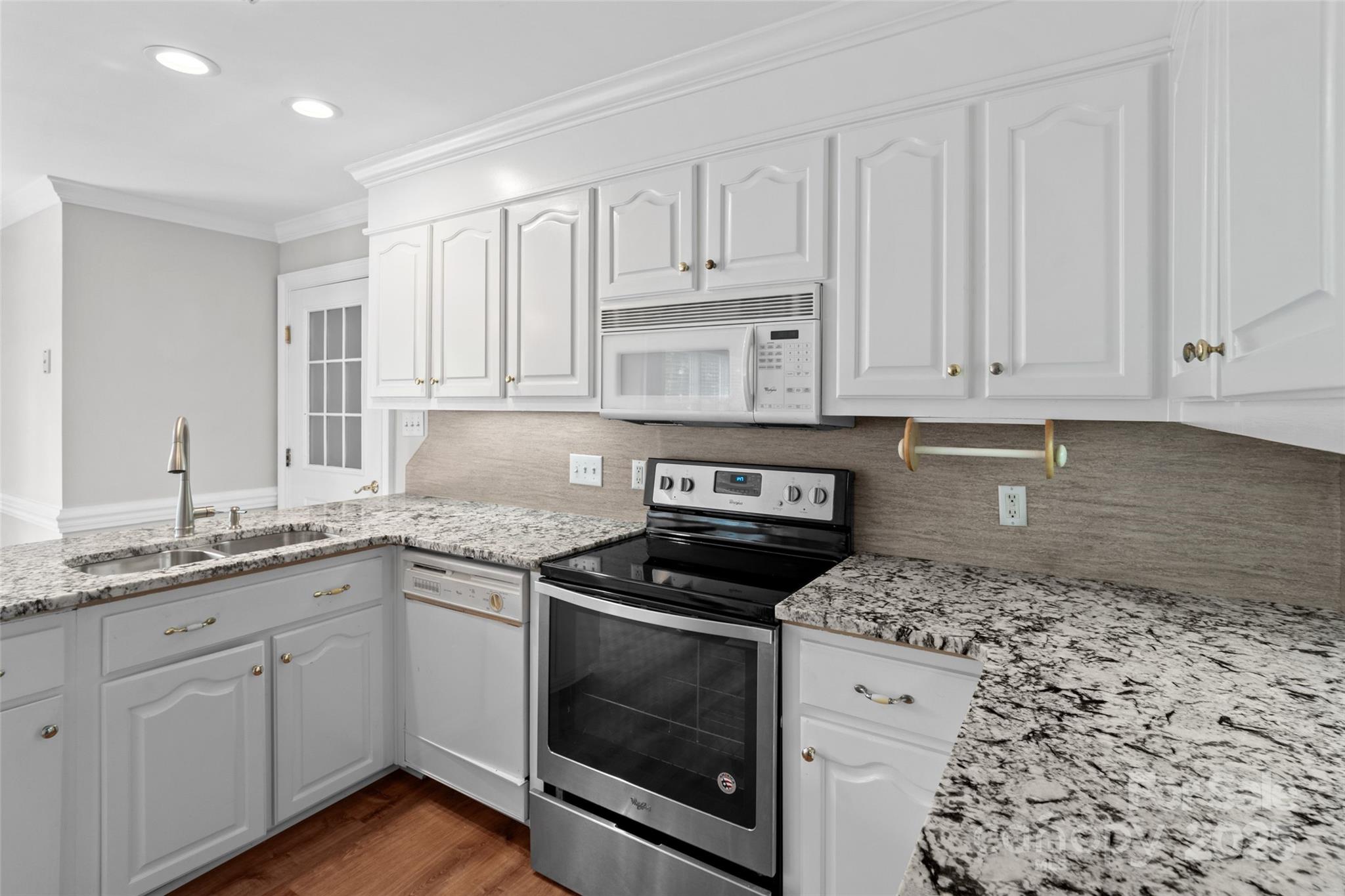 2082 Egret Court Rock Hill, SC 29732 - Photo 13 of 36 a kitchen with granite countertop white cabinets and stainless steel appliances