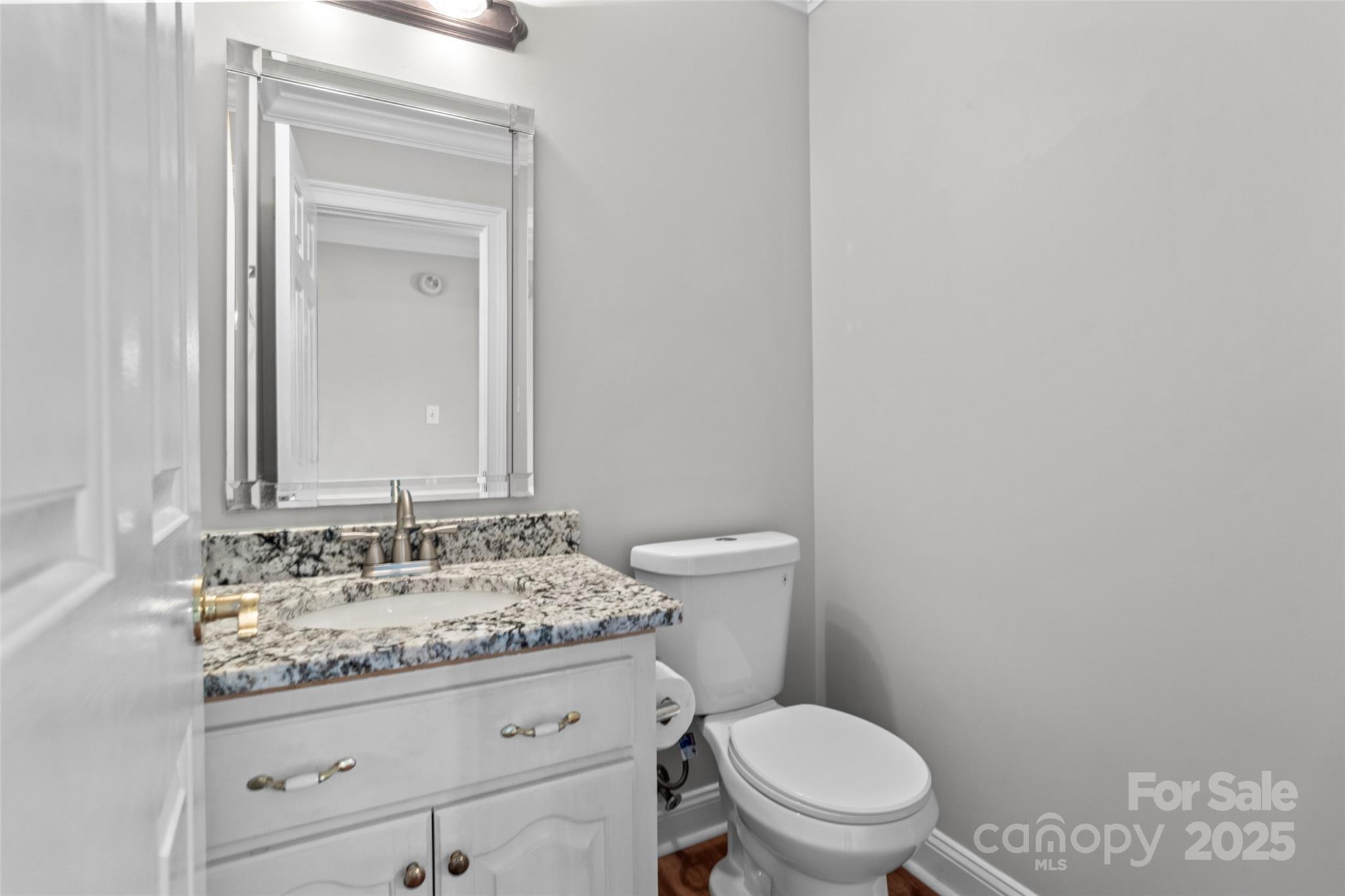 2082 Egret Court Rock Hill, SC 29732 - Photo 14 of 36 a bathroom with a granite countertop toilet sink and mirror
