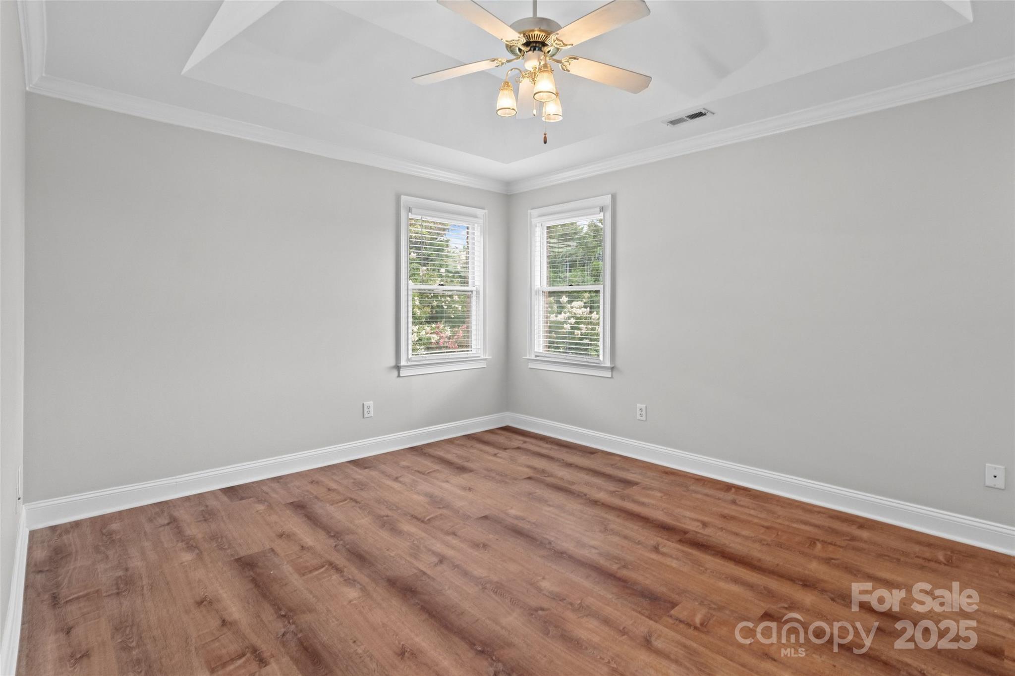 2082 Egret Court Rock Hill, SC 29732 - Photo 17 of 36 an empty room with wooden floor chandelier fan and windows