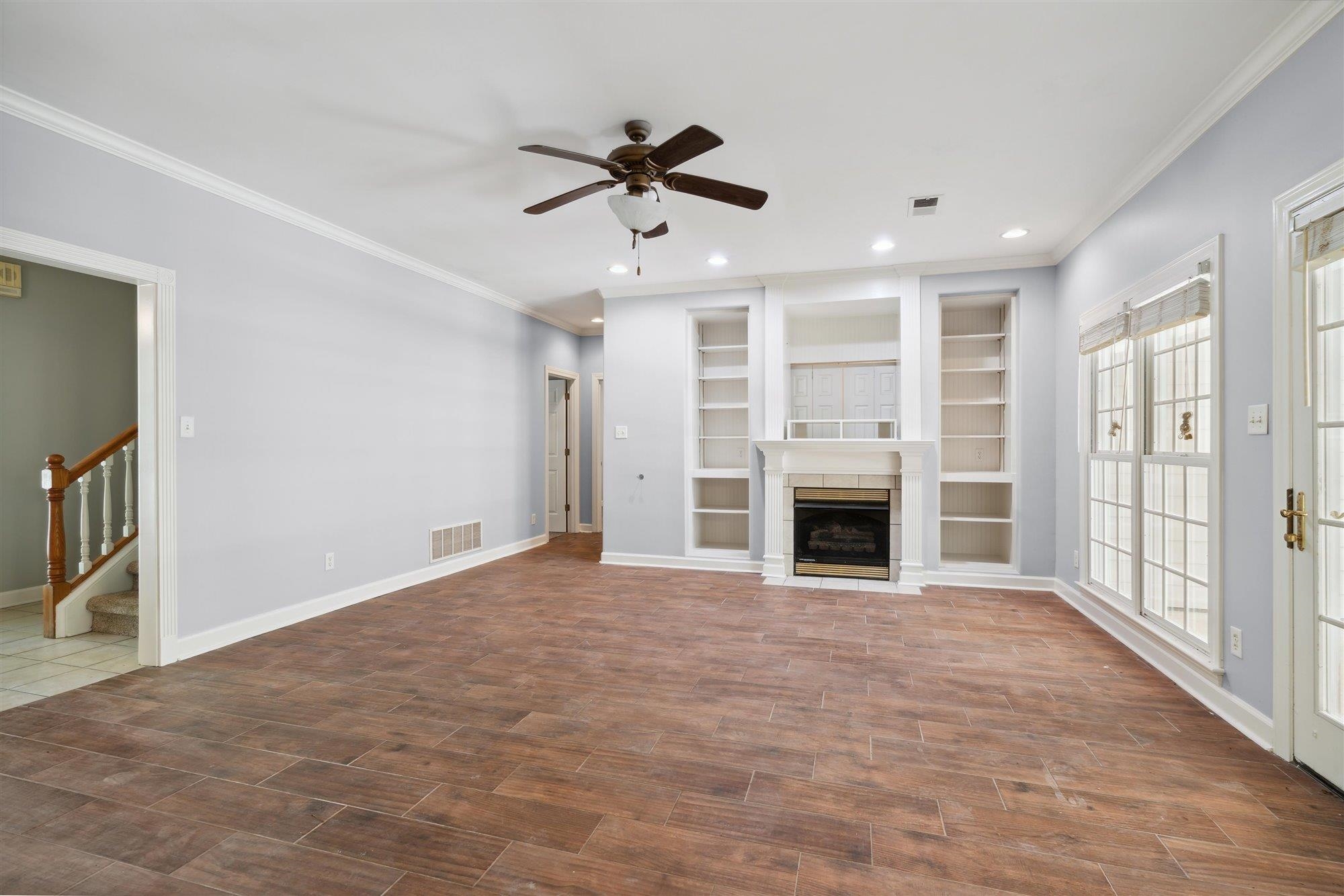 139 Pine Ridge Cove Holly Springs, MS 38635 - Photo 12 of 38 a view of an empty room with a fireplace and a window