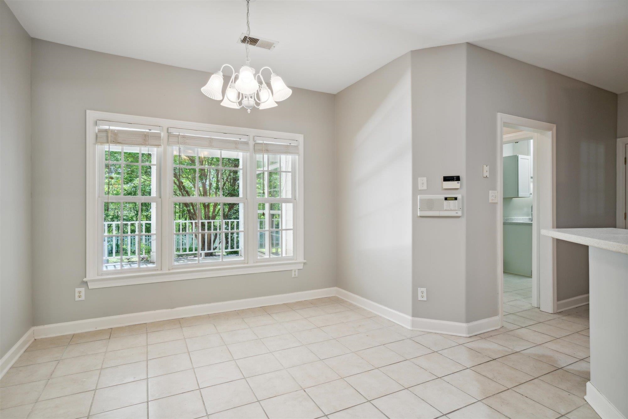 139 Pine Ridge Cove Holly Springs, MS 38635 - Photo 13 of 38 an empty room with chandelier and windows
