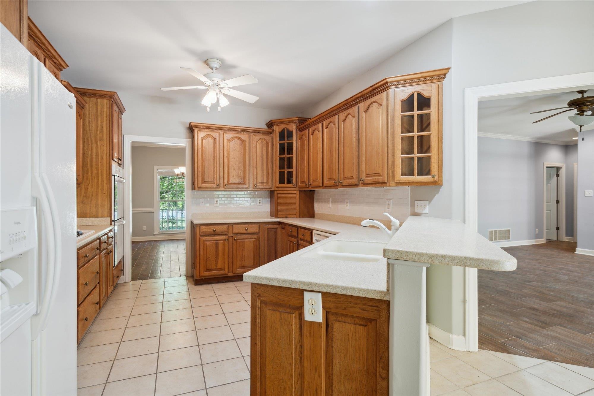 139 Pine Ridge Cove Holly Springs, MS 38635 - Photo 14 of 38 a kitchen with a stove a sink and a refrigerator