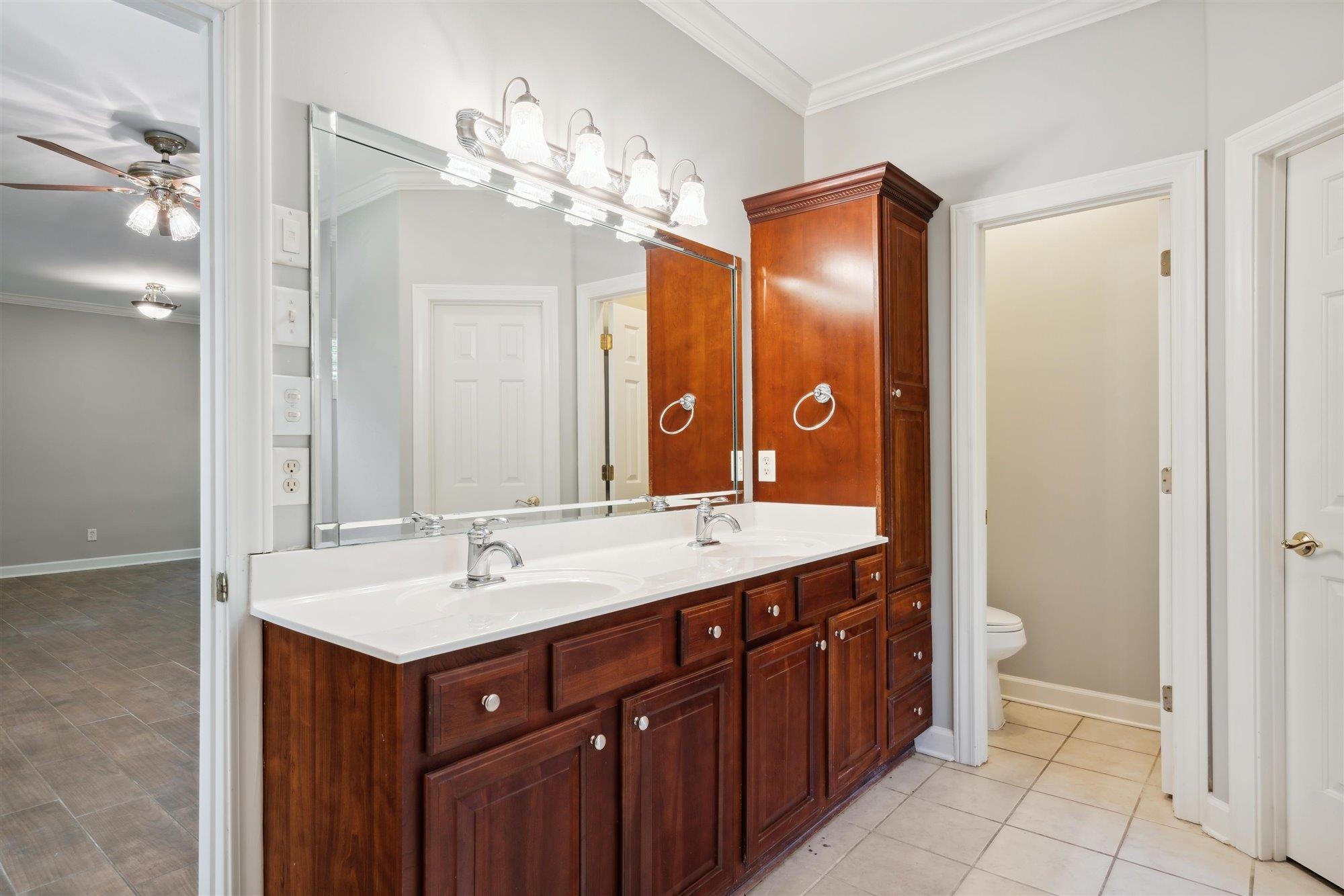 139 Pine Ridge Cove Holly Springs, MS 38635 - Photo 21 of 38 a bathroom with a sink vanity and a mirror