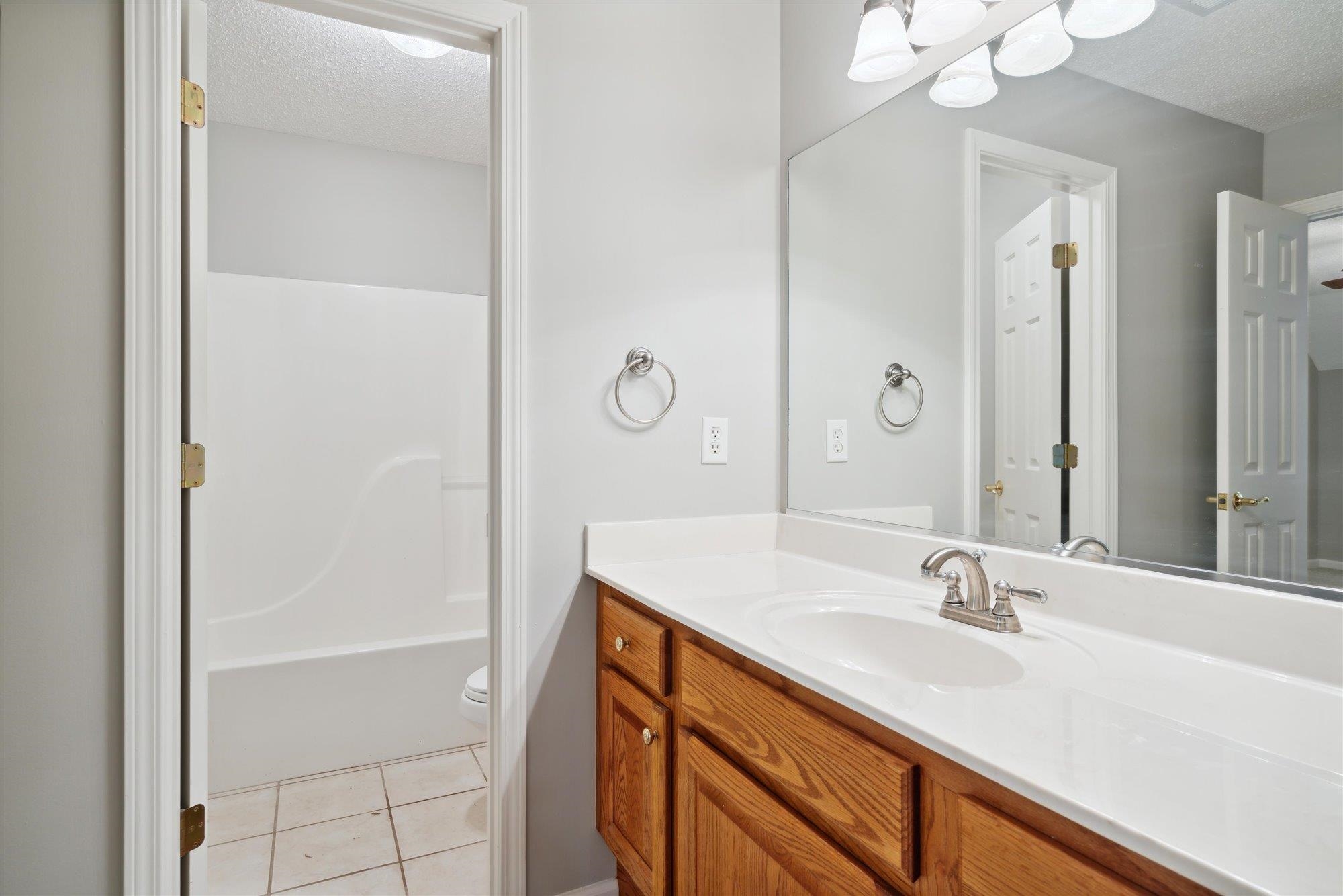 139 Pine Ridge Cove Holly Springs, MS 38635 - Photo 28 of 38 a bathroom with a sink and a mirror