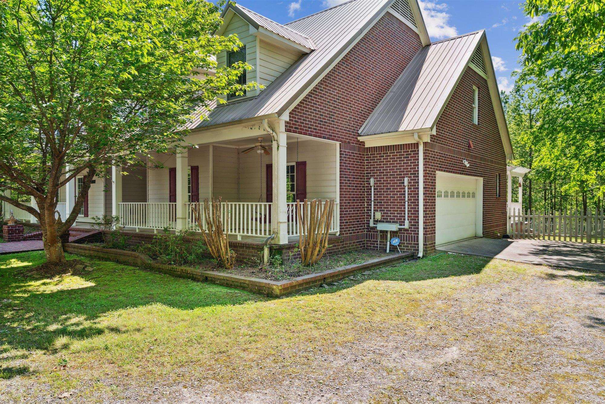 139 Pine Ridge Cove Holly Springs, MS 38635 - Photo 5 of 38 a view of a brick house with a large windows and large trees