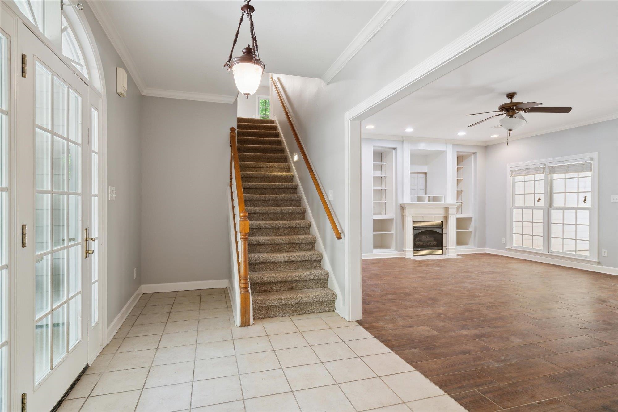 139 Pine Ridge Cove Holly Springs, MS 38635 - Photo 8 of 38 a view of an entryway with wooden floor and a chandelier