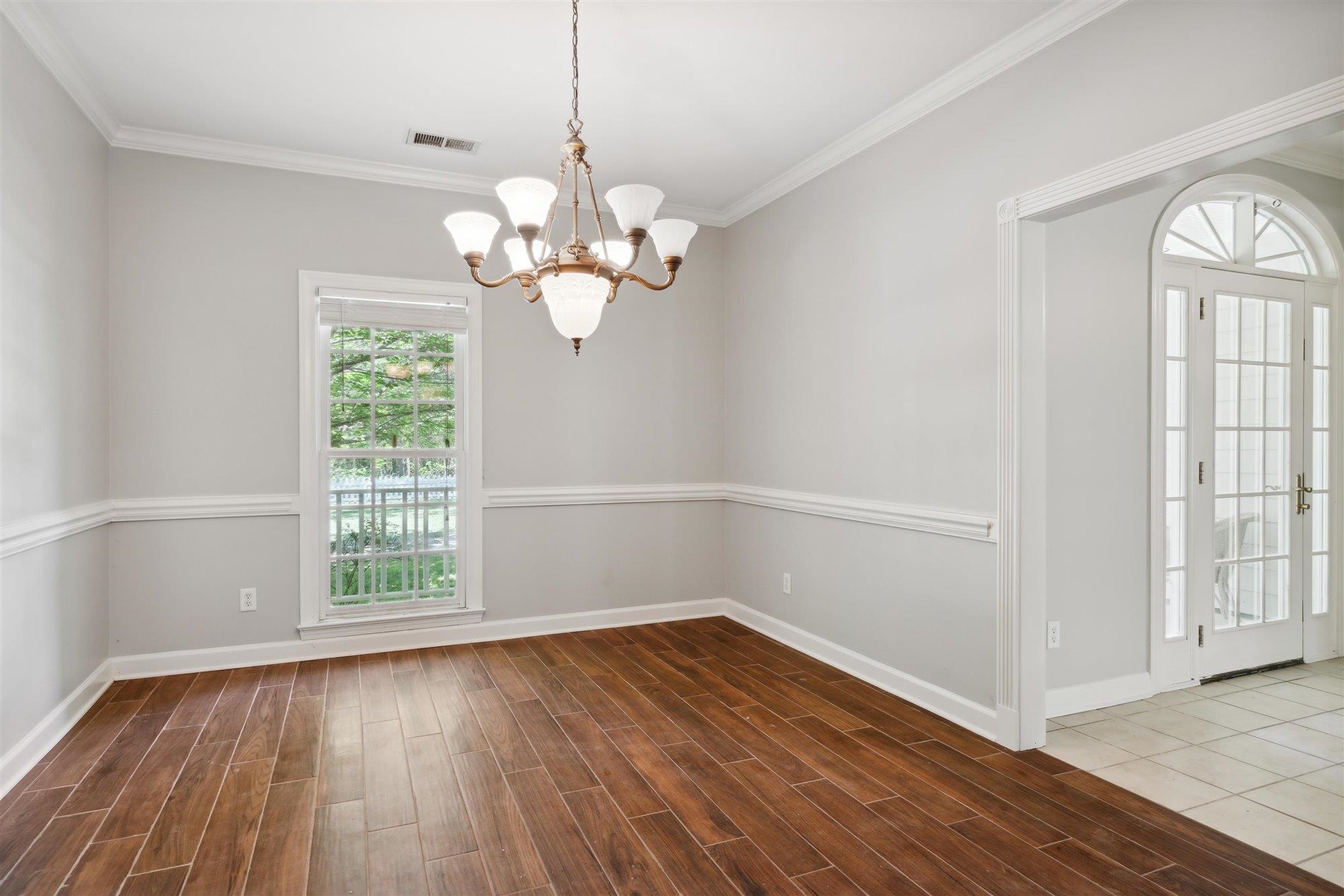 139 Pine Ridge Cove Holly Springs, MS 38635 - Photo 9 of 38 an empty room with wooden floor and windows