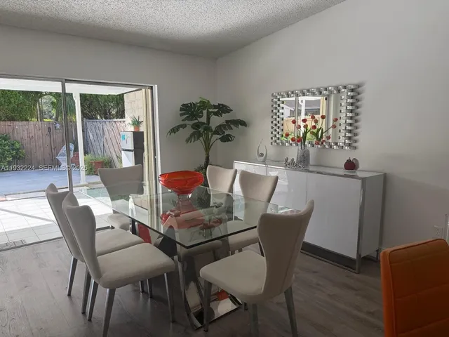a dining room with furniture and wooden floor