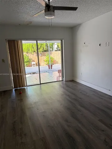an empty room with wooden floor and sliding door