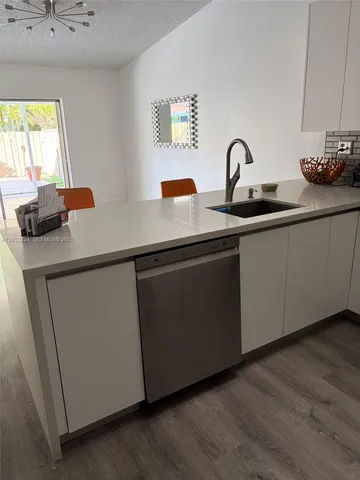 a kitchen with a sink and cabinets
