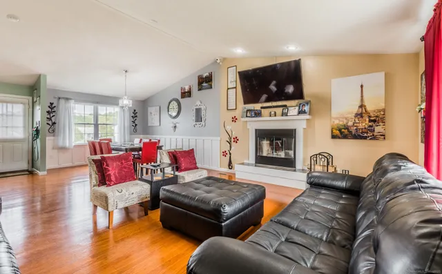 a living room with furniture fireplace and flat screen tv