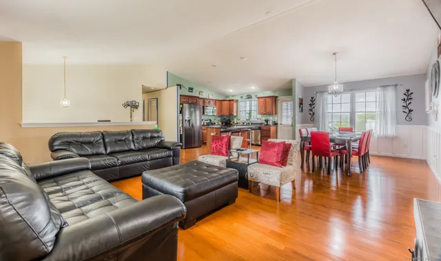 a living room with furniture and kitchen view