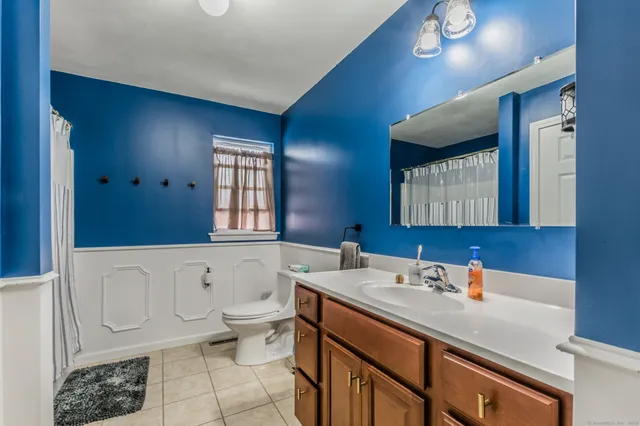 a bathroom with a sink a toilet and bathtub