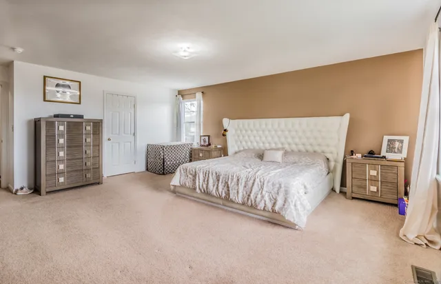 a spacious bedroom with a bed and cabinets