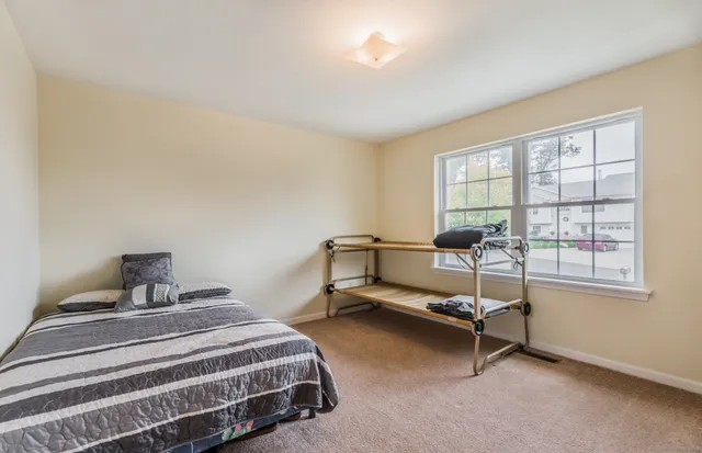 a bedroom with furniture and a window