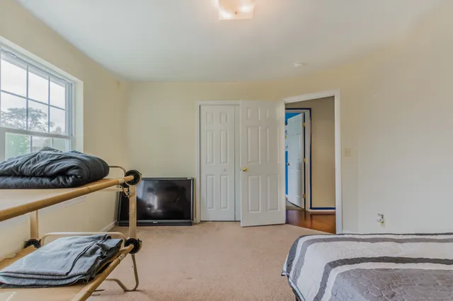 a bedroom with a bed and a chair