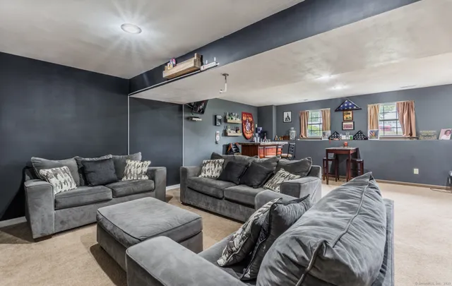 a living room with furniture and a ceiling fan