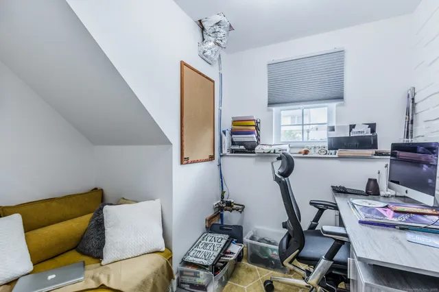 a work room with furniture and a flat screen tv