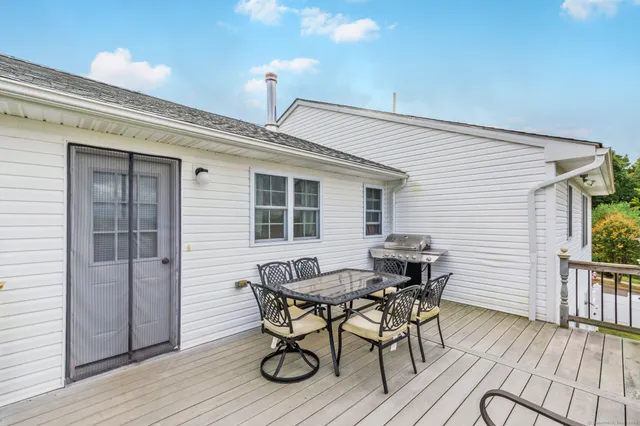 a view of a patio with table and chairs and wooden floor