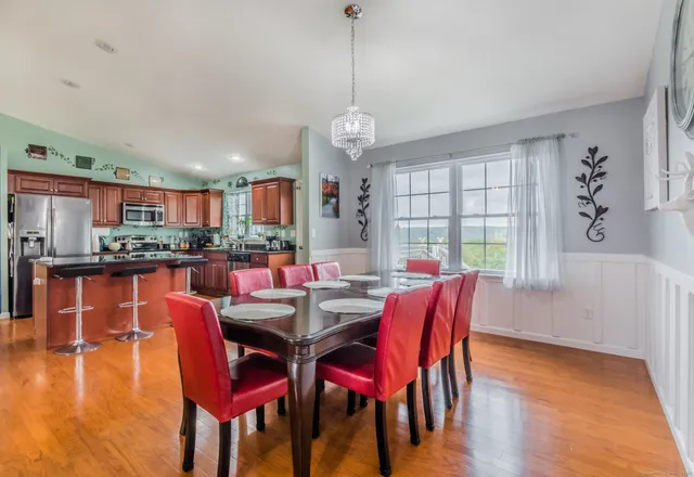 a dining room with furniture window and wooden floor