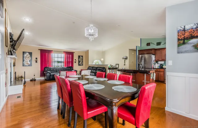 a view of a dining room with furniture and a potted plant