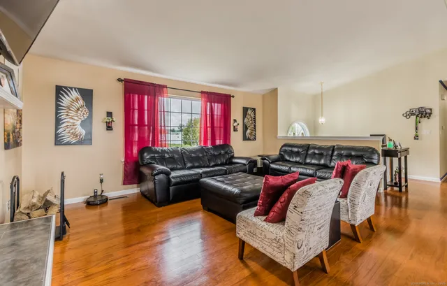 a living room with furniture and wooden floor