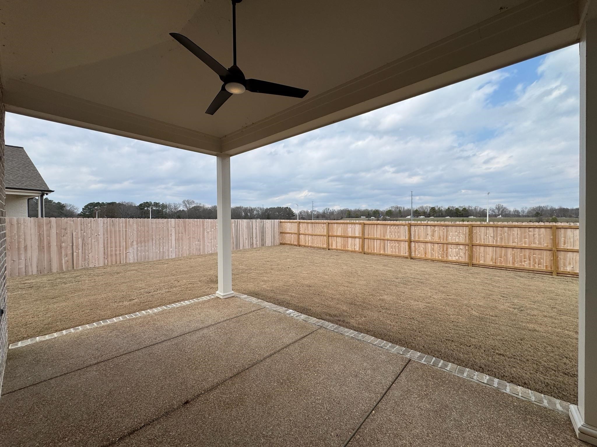 11512 Sunsparkler Way Collierville, TN 38017 - Photo 11 of 40 Fenced backyard with a ceiling fan and a patio