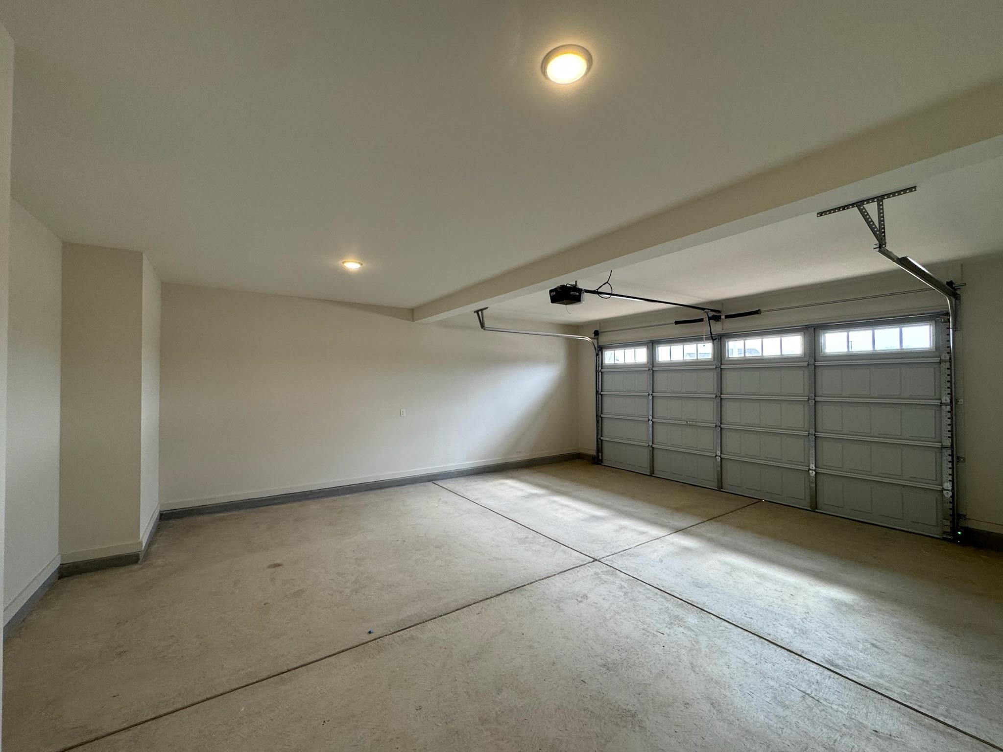 11512 Sunsparkler Way Collierville, TN 38017 - Photo 19 of 40 Garage with baseboards and a garage door opener