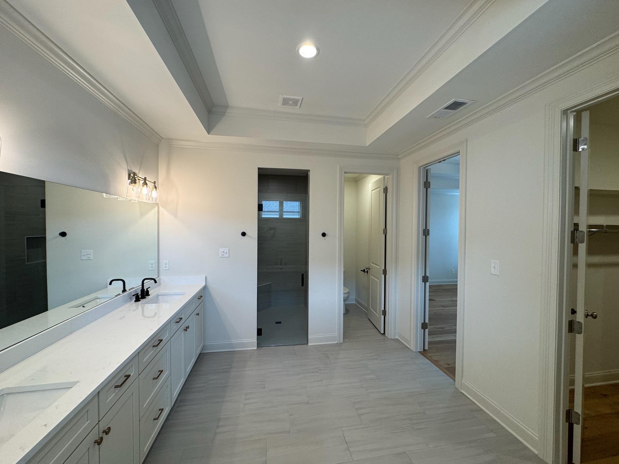 11512 Sunsparkler Way Collierville, TN 38017 - Photo 23 of 40 Full bathroom with double vanity, a stall shower, crown molding, and a raised ceiling